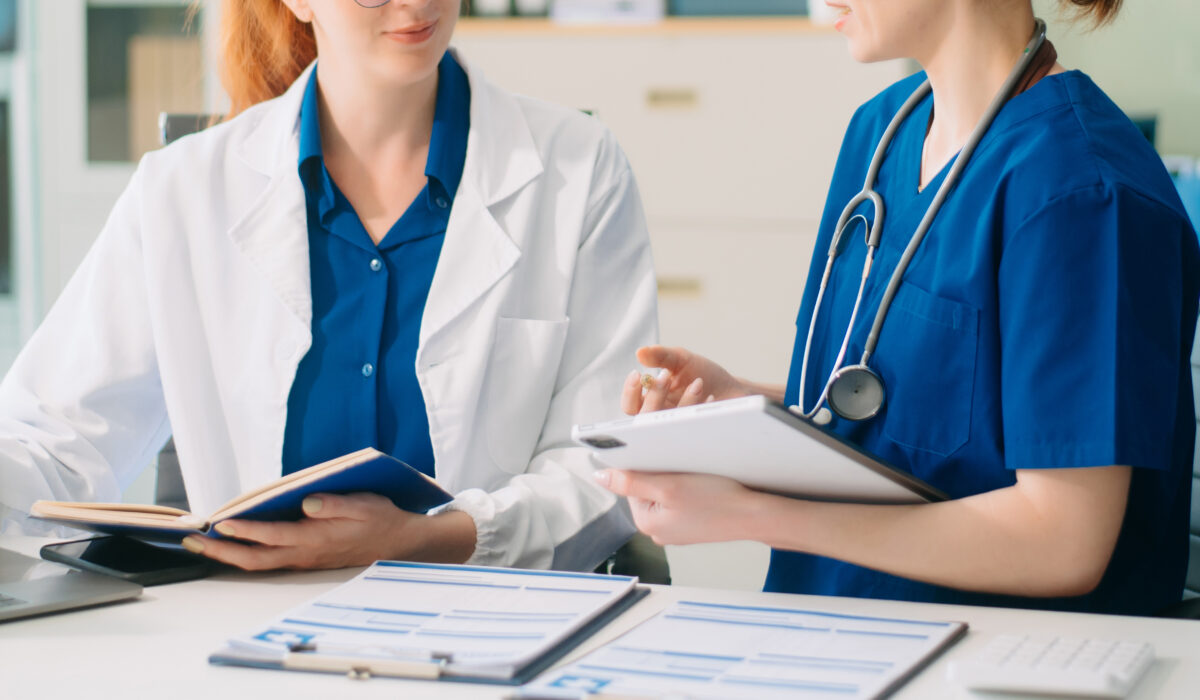 Doctor and nurse team using laptop to review medical results