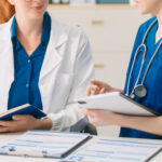 Doctor and nurse team using laptop to review medical results