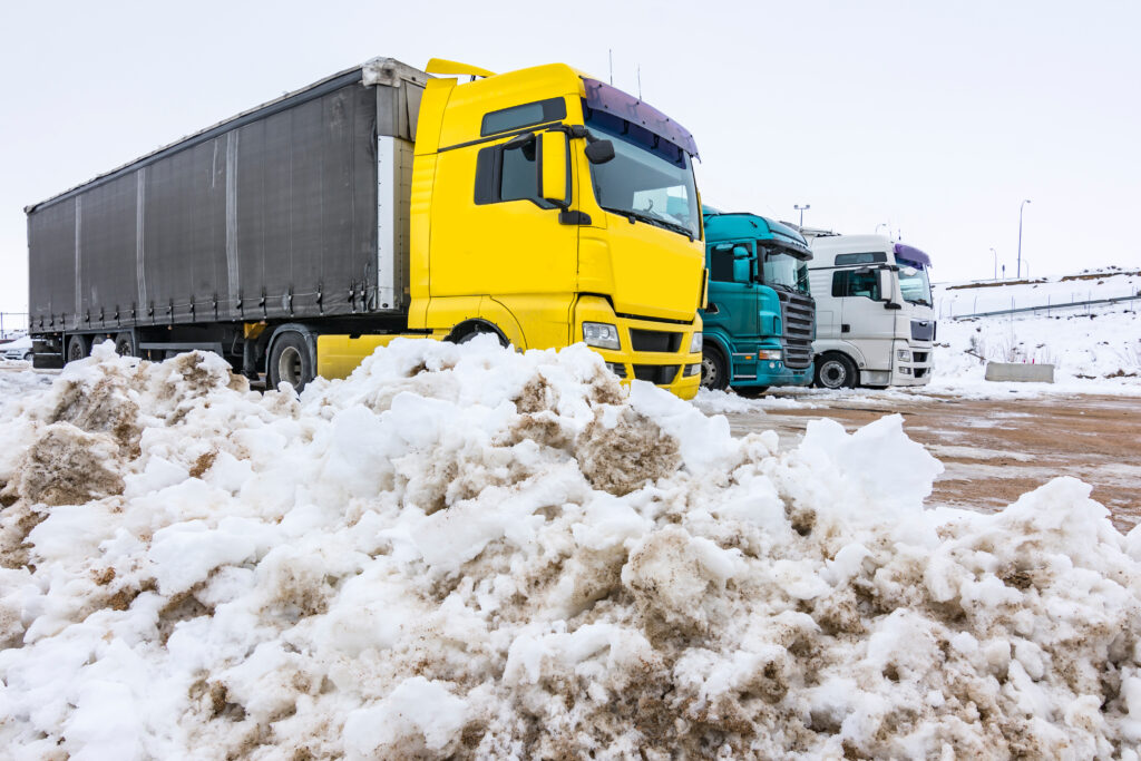 Trucks stopped at rest stop amidst snow