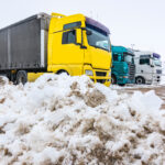 Trucks stopped at rest stop amidst snow