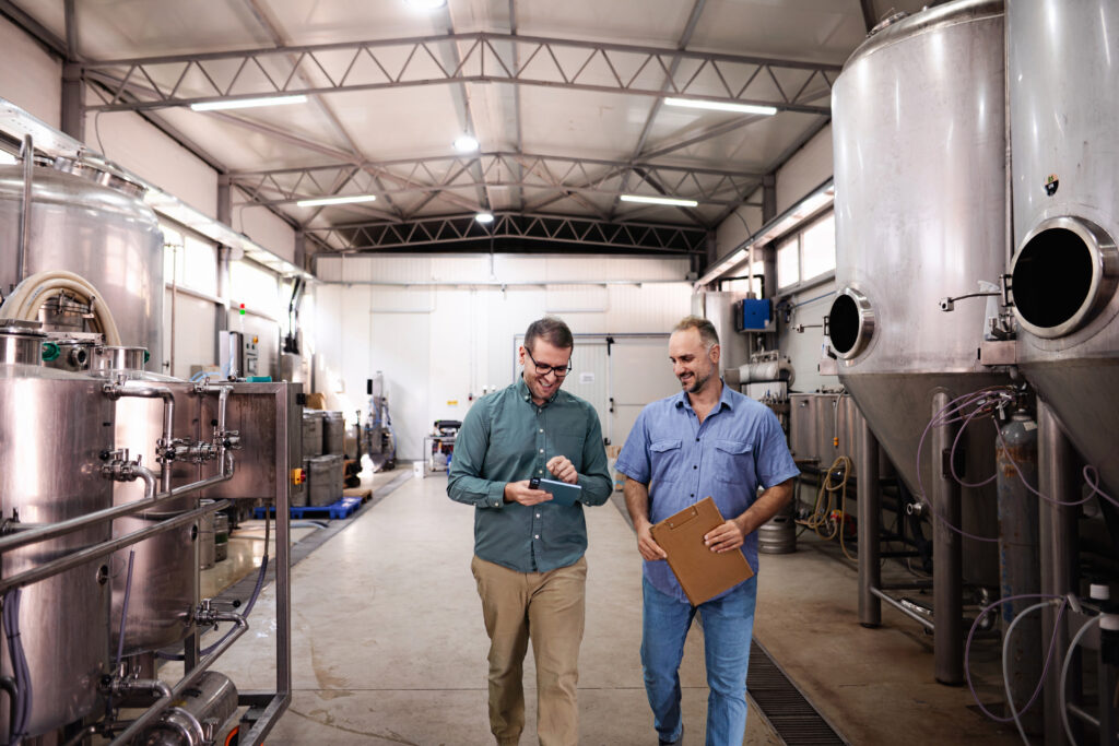Brewery owners inspecting equipment
