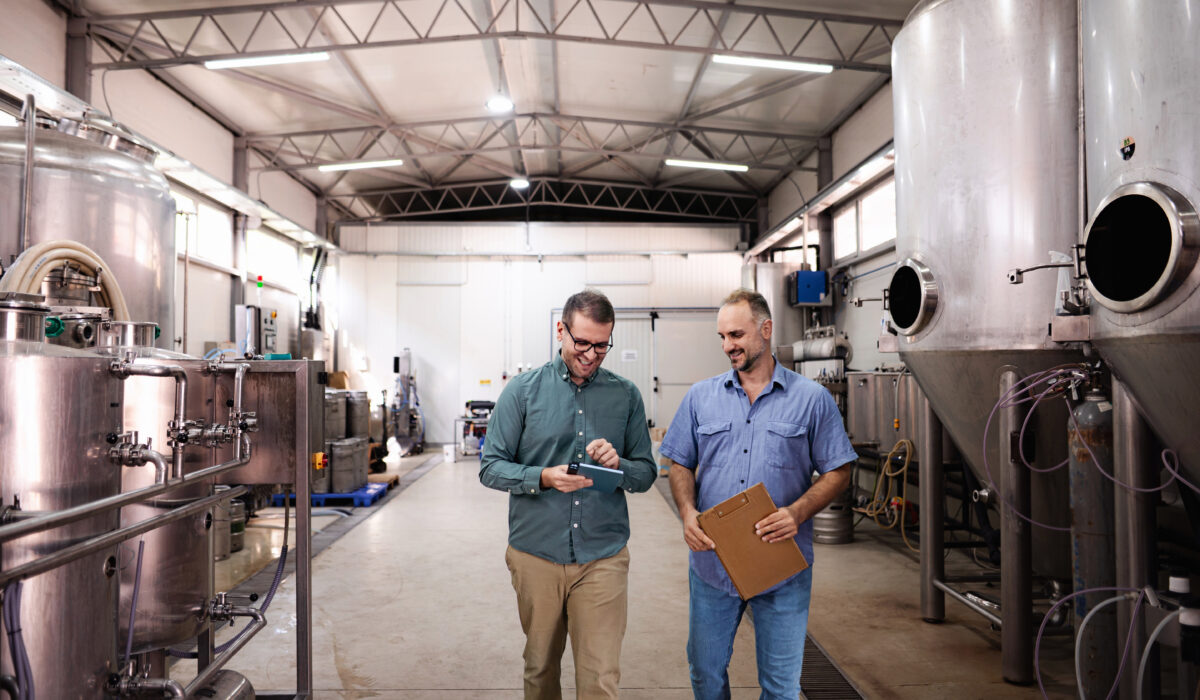Brewery owners inspecting equipment