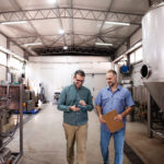 Brewery owners inspecting equipment