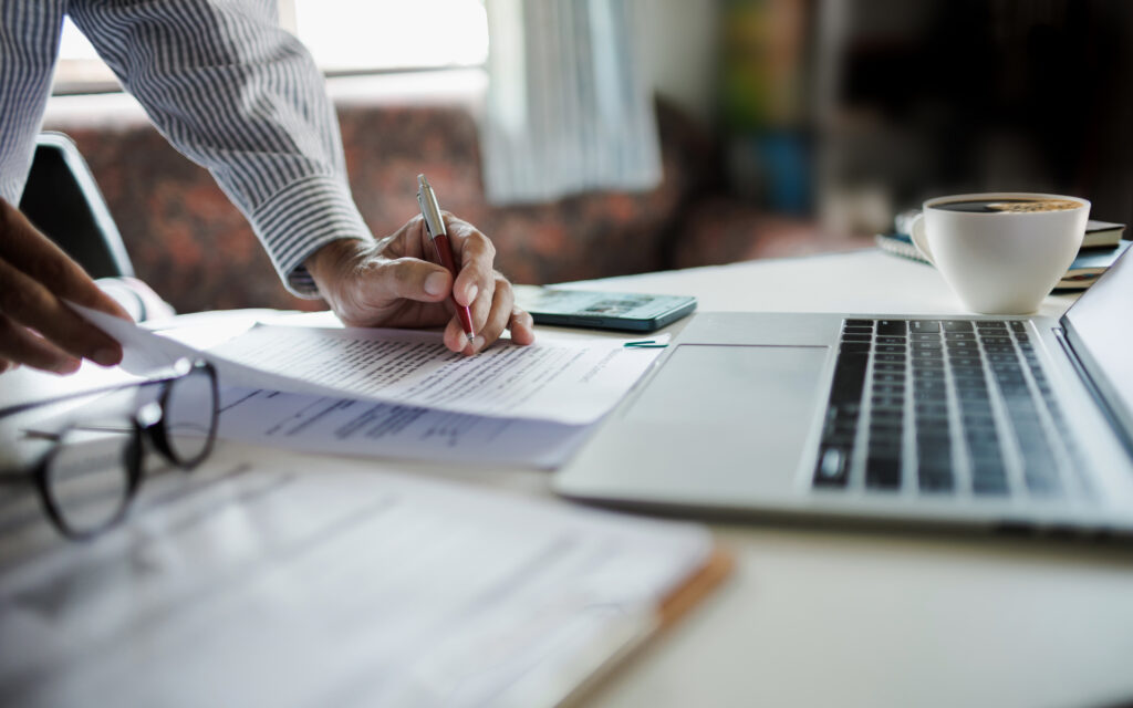 Business owner reviewing equipment financing documents while planning reinvestment after tax season.