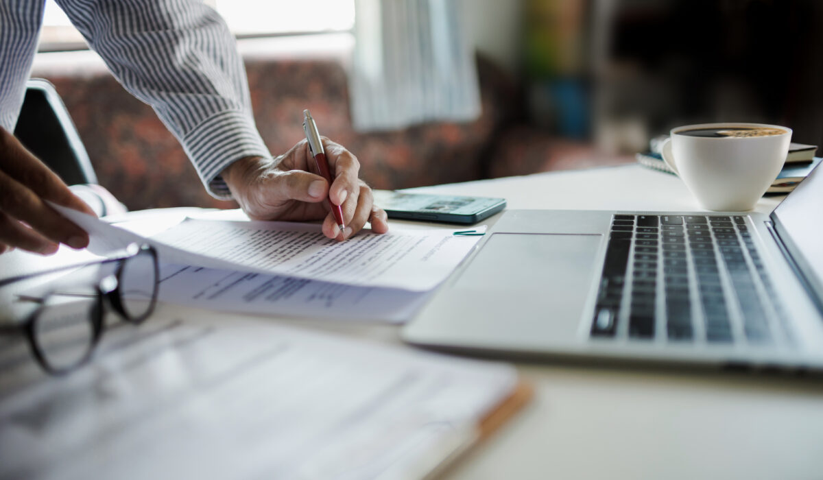 Business owner reviewing equipment financing documents while planning reinvestment after tax season.