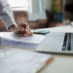Business owner reviewing equipment financing documents while planning reinvestment after tax season.