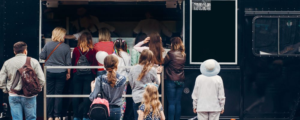 line of customers at blue food truck